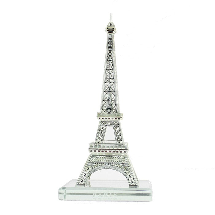 Miniature de la Tour Eiffel en cristal brillant, posée dans un écrin élégant.