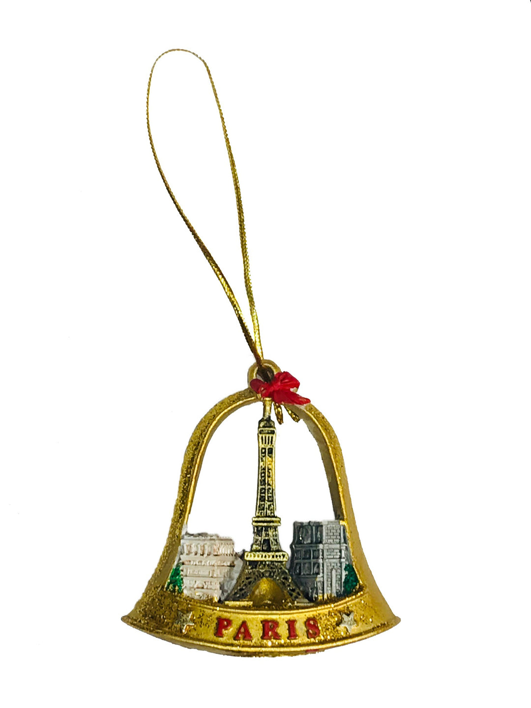 Cloche de Noël dorée représentant la Tour Eiffel, l'Arc de Triomphe et Notre-Dame de Paris, posée sur une surface avec des paillettes scintillantes